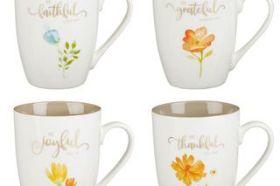 The Grateful Ceramic Mug Set includes four creamy-colored ceramic mugs in a beautifully designed floral gift box with a see-through lid. Each mug features an encouraging phrase from Scripture, a larger floral design on the front, and a smaller floral accent on the back. The mugs are white on the outside and a light taupe on the inside. Gold foil is used for the lettering. The sentiment on each mug reads: Be Thankful Colossians 3:15 Be Grateful Hebrews 12:28 Be Faithful Luke 16:10 Be Joyful Habakkuk 3:18 The sentiment is elegantly scripted in gold foil and accented with a flower in shades of light orange, gold, and blue. These mugs are fresh and cheerful with a touch of elegance and communicate a positive, uplifting message. The Grateful Ceramic Mug Set is a thoughtful gift for a friend who would appreciate the reminder to be grateful, joyful, thankful, and faithful for herself, her family, and her guests. The Grateful Ceramic Mug Set can be given as a housewarming gift, birthday gift, or wedding shower gift. It would be extra special when paired with any of our other fabulous gifts from the Be Grateful Collection that include a coordinating teapot, pie plate, tea towel, spoon rest, utensil holder, ceramic trivet, glass cutting board, or apron. Set includes: 4 Ceramic Mugs Hand-wash Recommended Gold Foil Not Dishwasher or Microwave Safe due to Foil Packaged in Gift Box with See-through Lid Gift Box Dimensions: 9.3" x 9.3" x 3.6" (236 x 236 x 91 mm) Capacity 12 fl. oz. each (355 ml each)